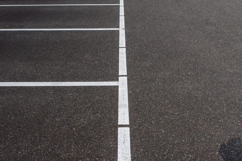 Fresh white parking-space lines in a Baton Rouge parking lot